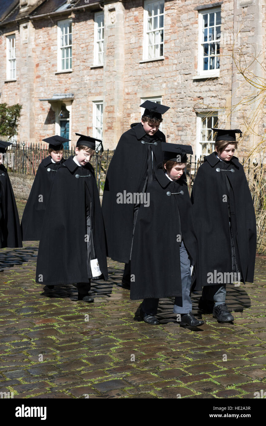 Choristers from Wells Cathedral Choir walking along Vicars Close in cloaks to evensong at the Cathedral on Easter Day. Stock Photo