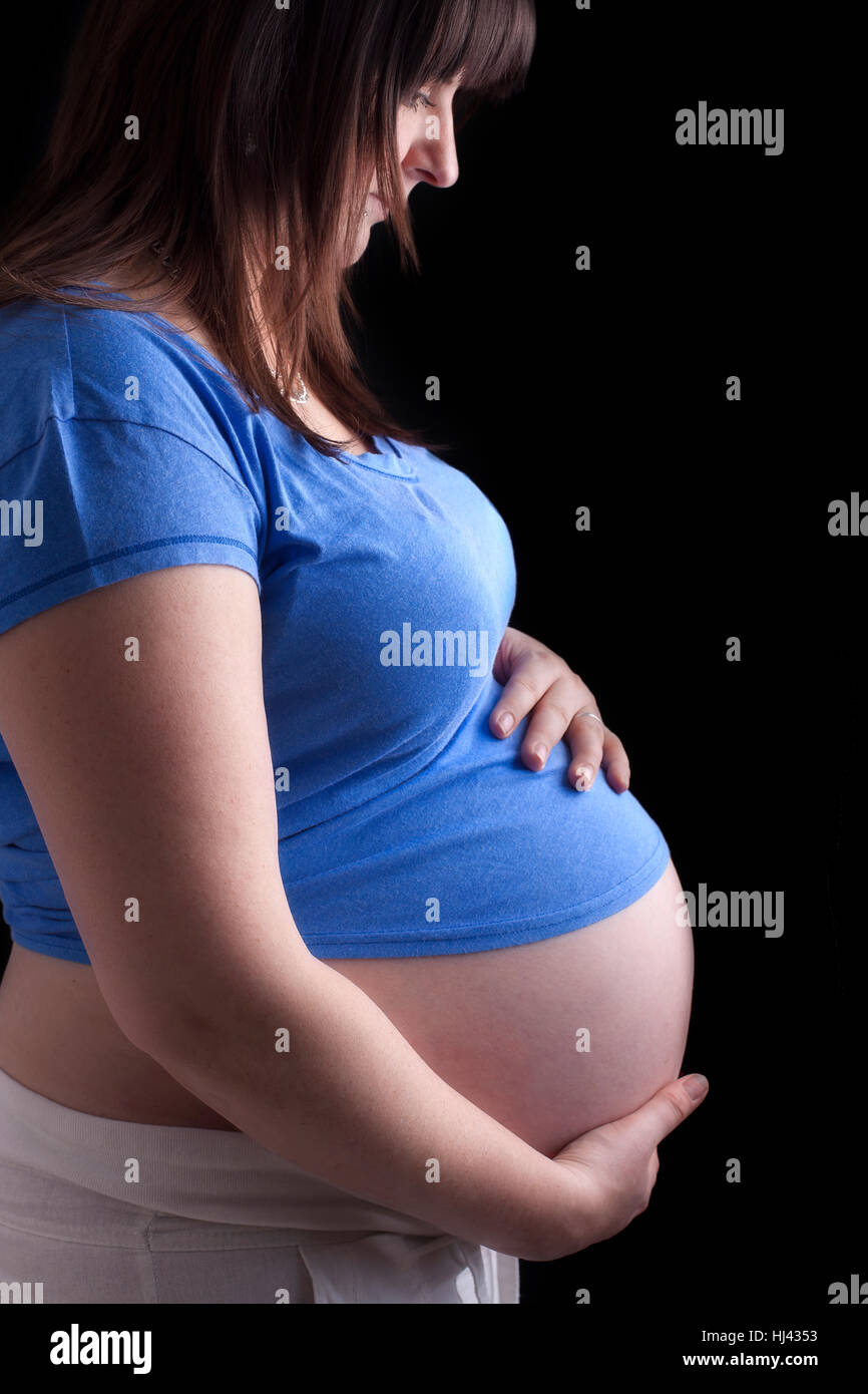 pregnant woman holding her belly Stock Photo - Alamy