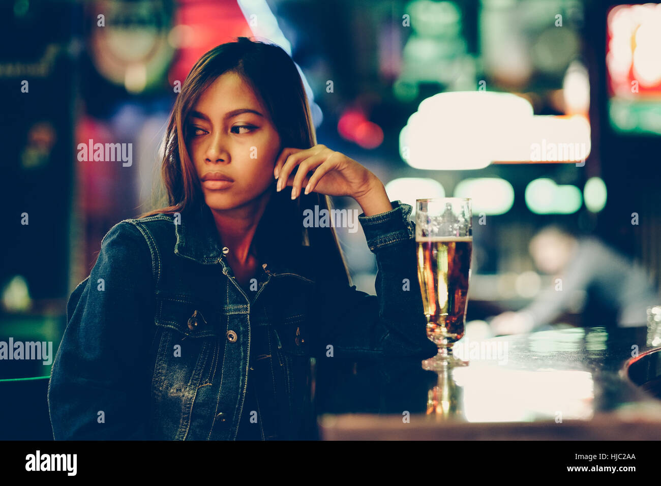 Night life, adult girl waiting in the Bar drinking bear Stock Photo