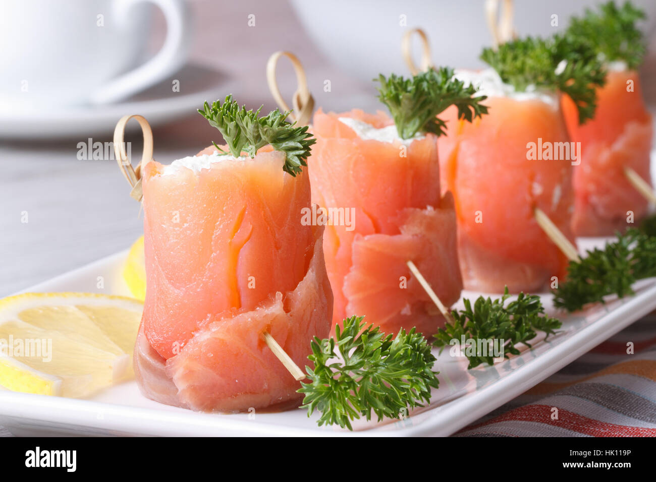 Finger food. Rolls of red fish with cream cheese close-up on the table horizontal Stock Photo