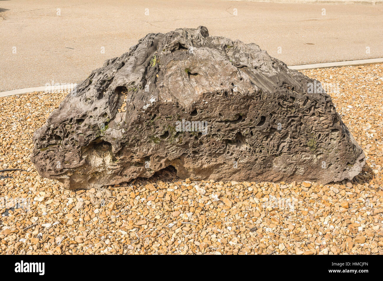 Large Boulder With Gravel Background. Stock Photo