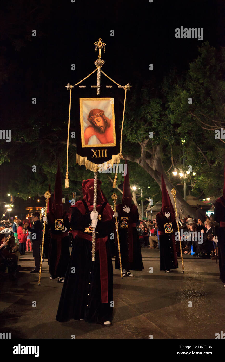 Penitents during Semana Santa in Malaga, Spain Stock Photo