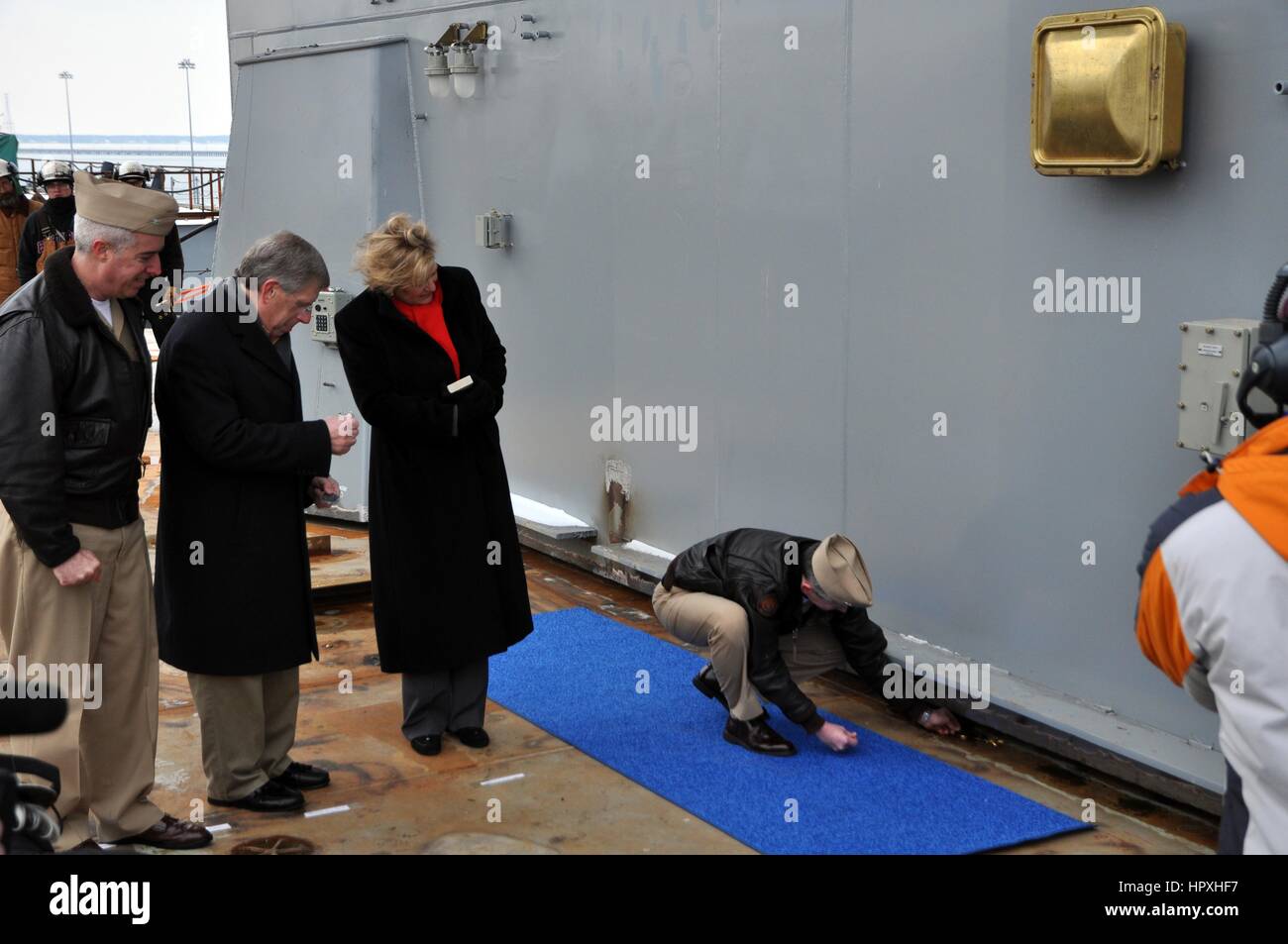 Admiral Ted N. Branch, commander of Naval Air Force Atlantic, places several coins under the island of the future nuclear-powered aircraft carrier USS Gerald R. Ford during the ship's island landing ceremony, Huntington Ingalls Industries-Newport News Shipbuilding, January 26, 2013. Image courtesy Nathanael Miller/US Navy. Stock Photo