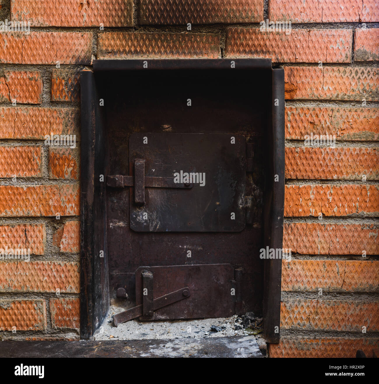 iron stove in the Russian sauna lined with red brick Stock Photo