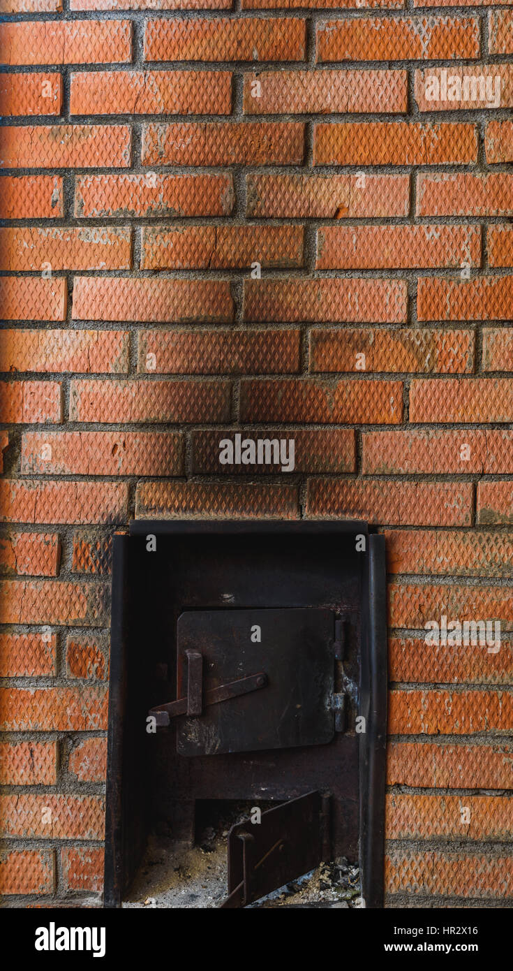 iron stove in the Russian sauna lined with red brick Stock Photo