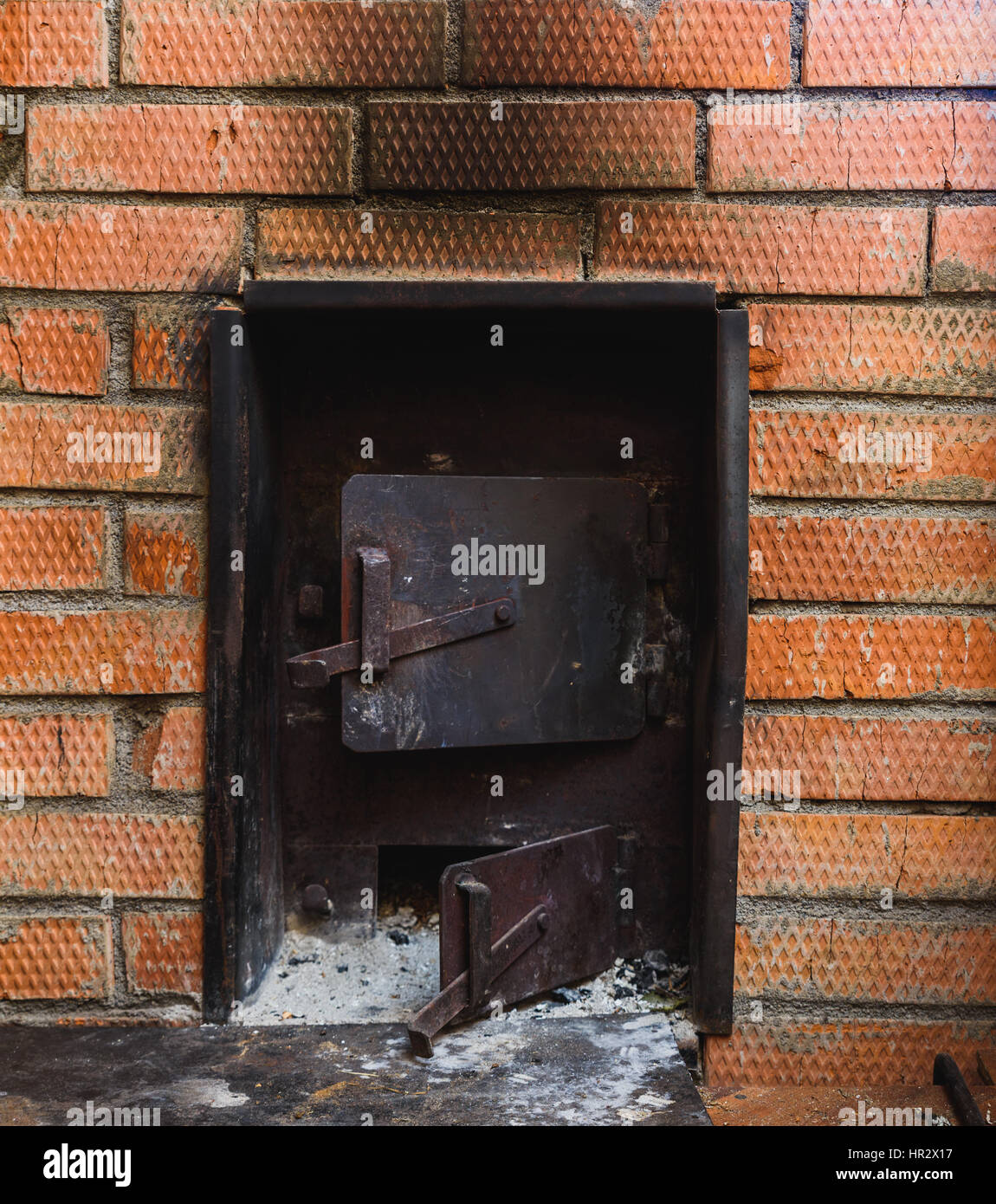 iron stove in the Russian sauna lined with red brick Stock Photo