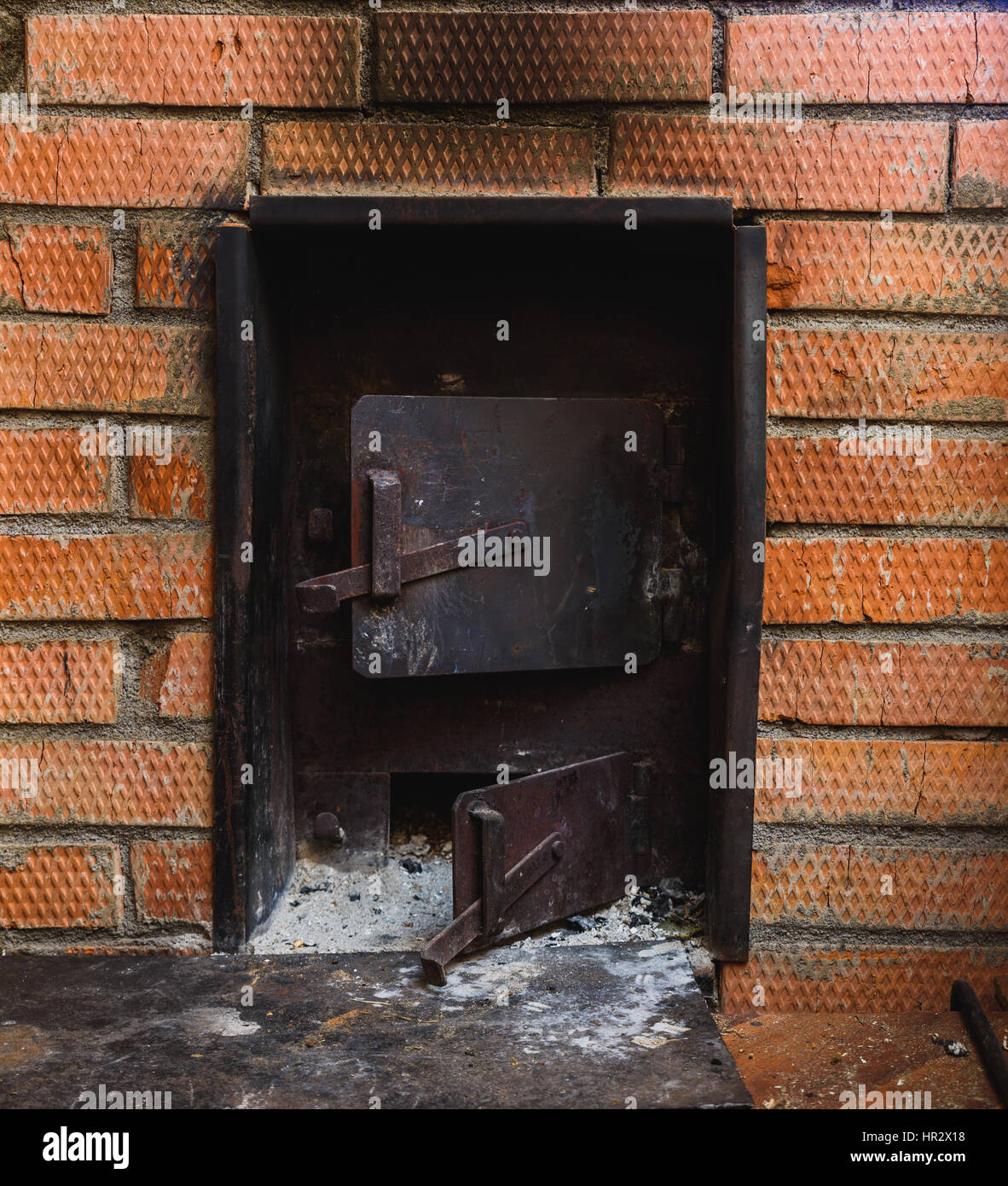 iron stove in the Russian sauna lined with red brick Stock Photo