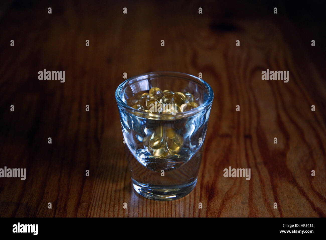 Pills in a shot glass Stock Photo