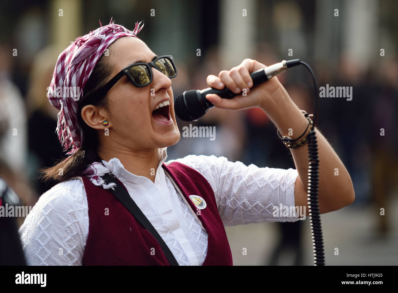 Angry woman. Million Women Rise march in London from Oxford Street to Trafalgar Square, UK. Chanting into microphone Stock Photo