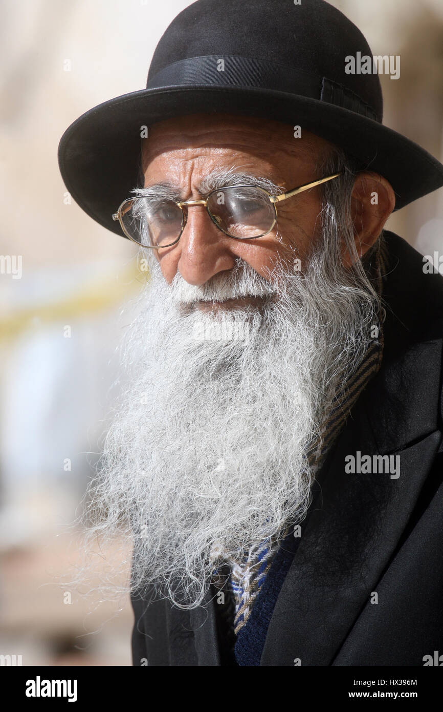 Jewish men pray at the western wall in Jerusalem, IL. The wall is one of the holiest sites in Judaism attracting thousands of worshipers daily Stock Photo