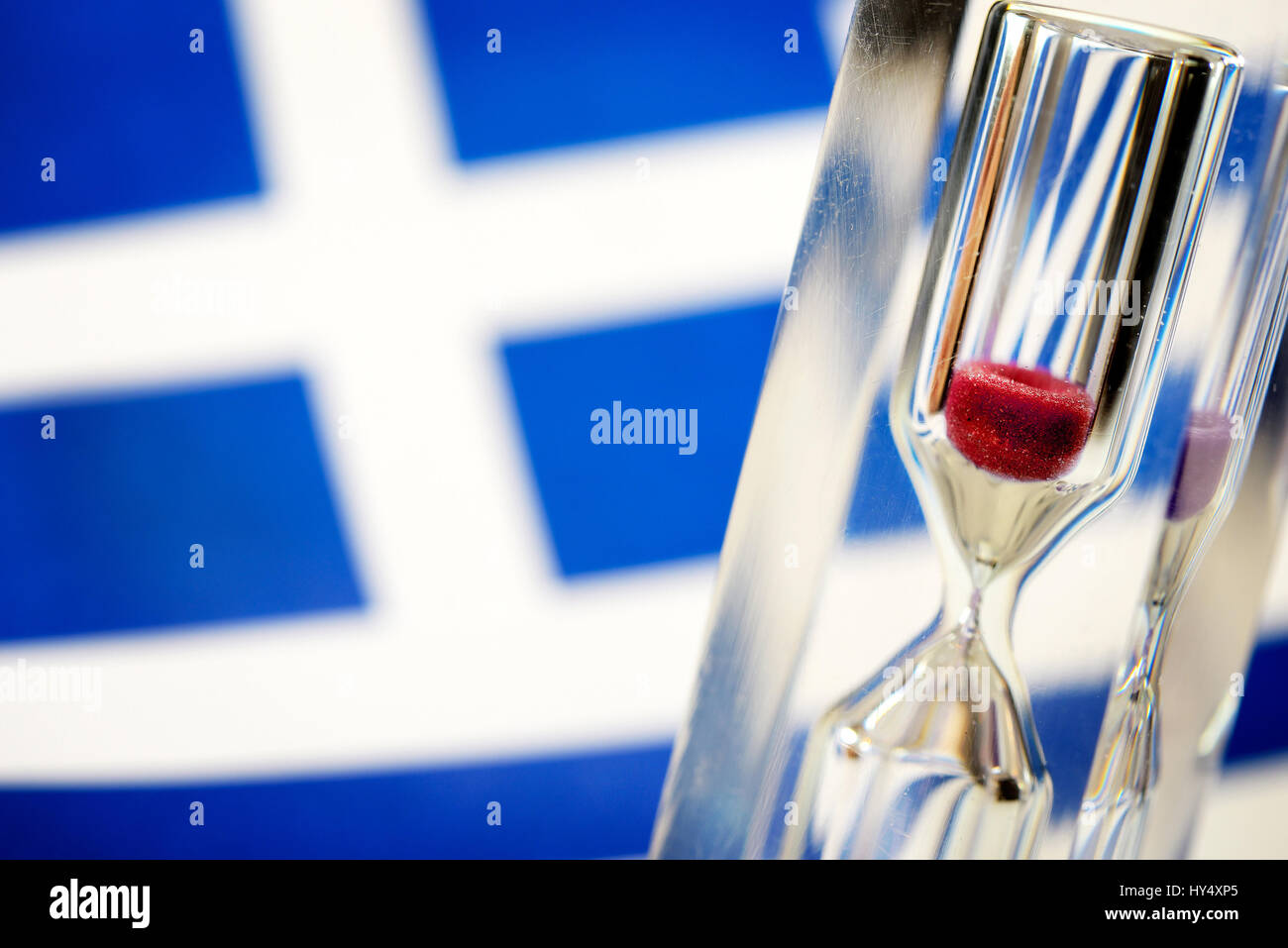 Greek flag and hourglass, symbolic photo Greek debt crisis, Griechische Fahne und Sanduhr, Symbolfoto griechische Schuldenkrise Stock Photo