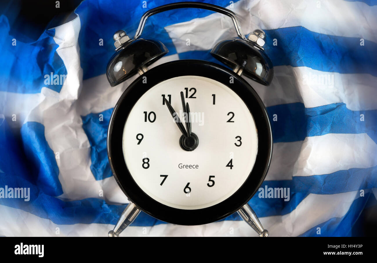 Alarm clock on five before twelve on crumpled up Greece flag, symbolic photo debt quarrel, Wecker auf Fuenf vor Zwoelf auf zerknuellter Griechenlandfa Stock Photo