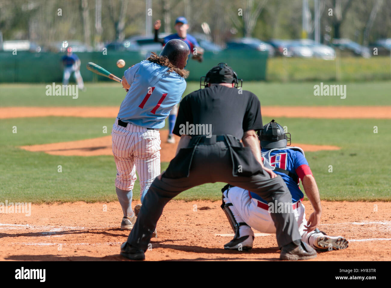 Baseball batter hits ball Stock Photo