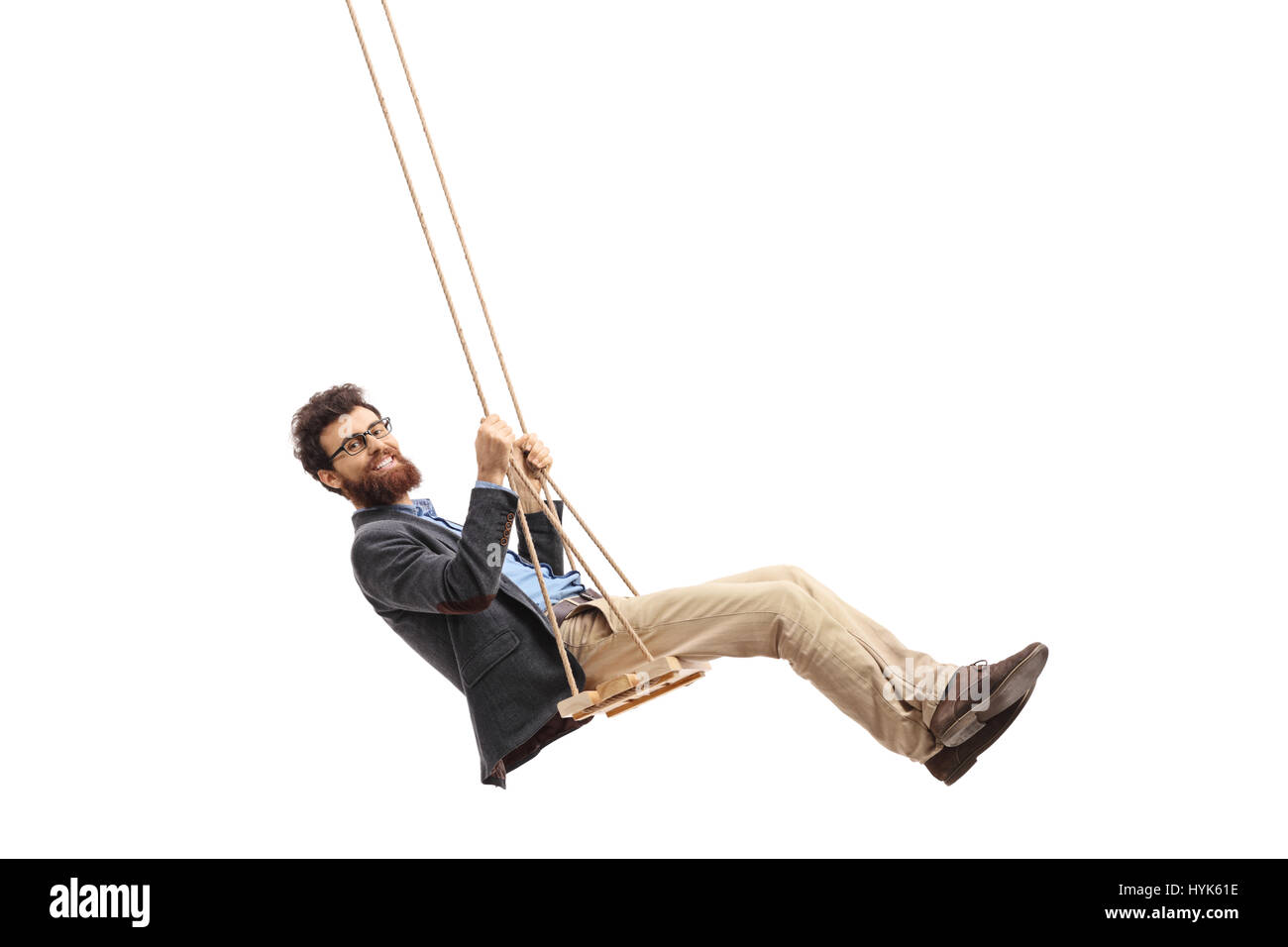 Bearded man swinging on a swing and looking at the camera isolated on white background Stock Photo