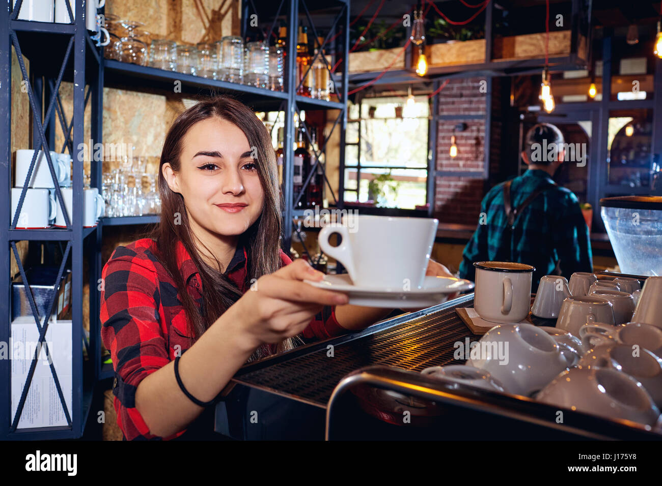 The barman girl works at bar in  restaurant Stock Photo