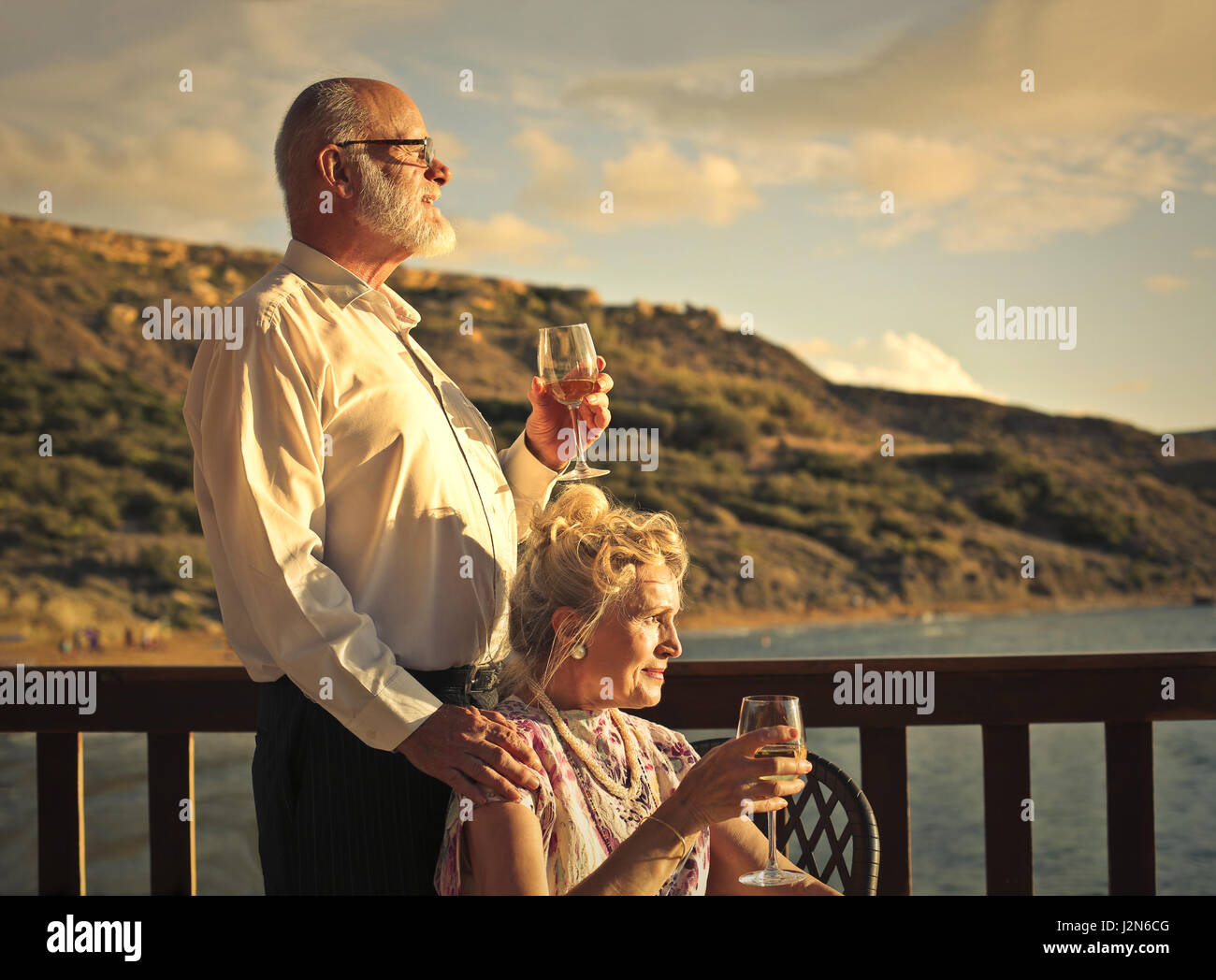 Old couple drinking wine together Stock Photo