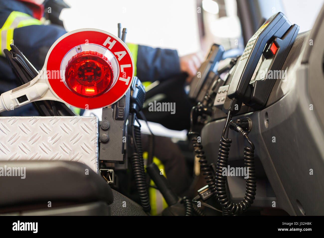 Firefighter drives a emergency vehicle with communication interior view and trowel Stock Photo