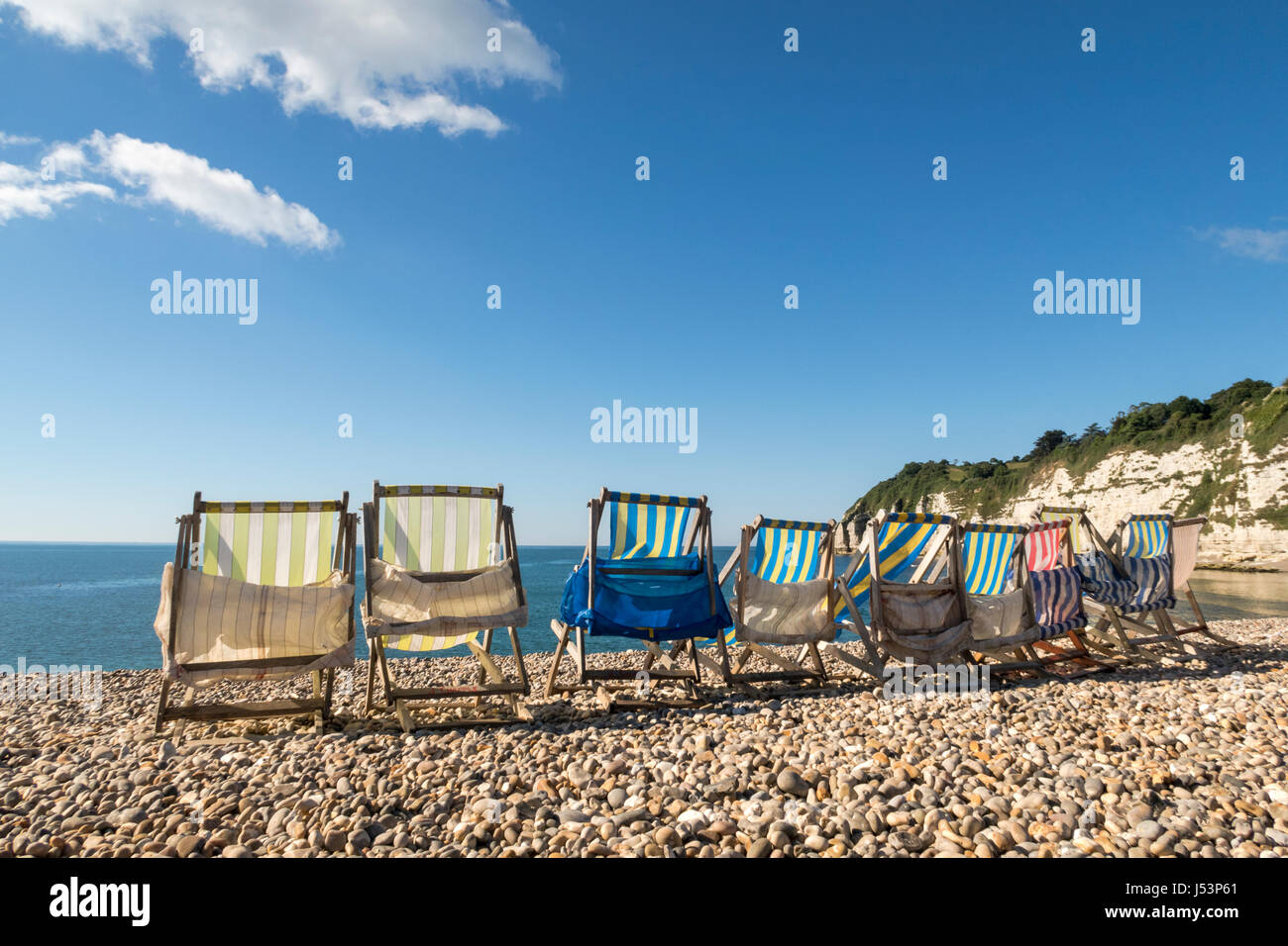 row of deck chairs at Beer beach, Devon, UK Stock Photo