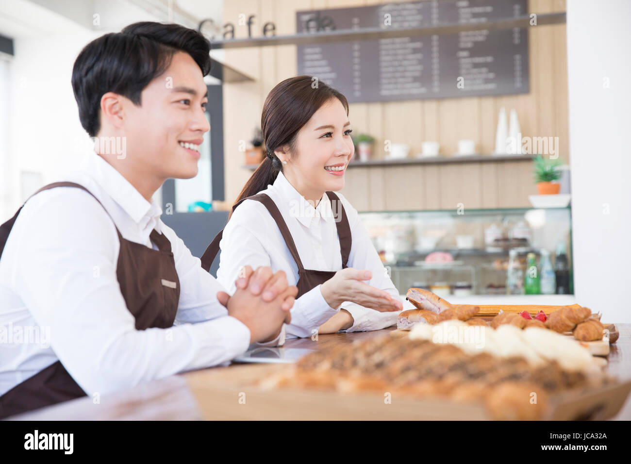 Smiling workers at bakery Stock Photo