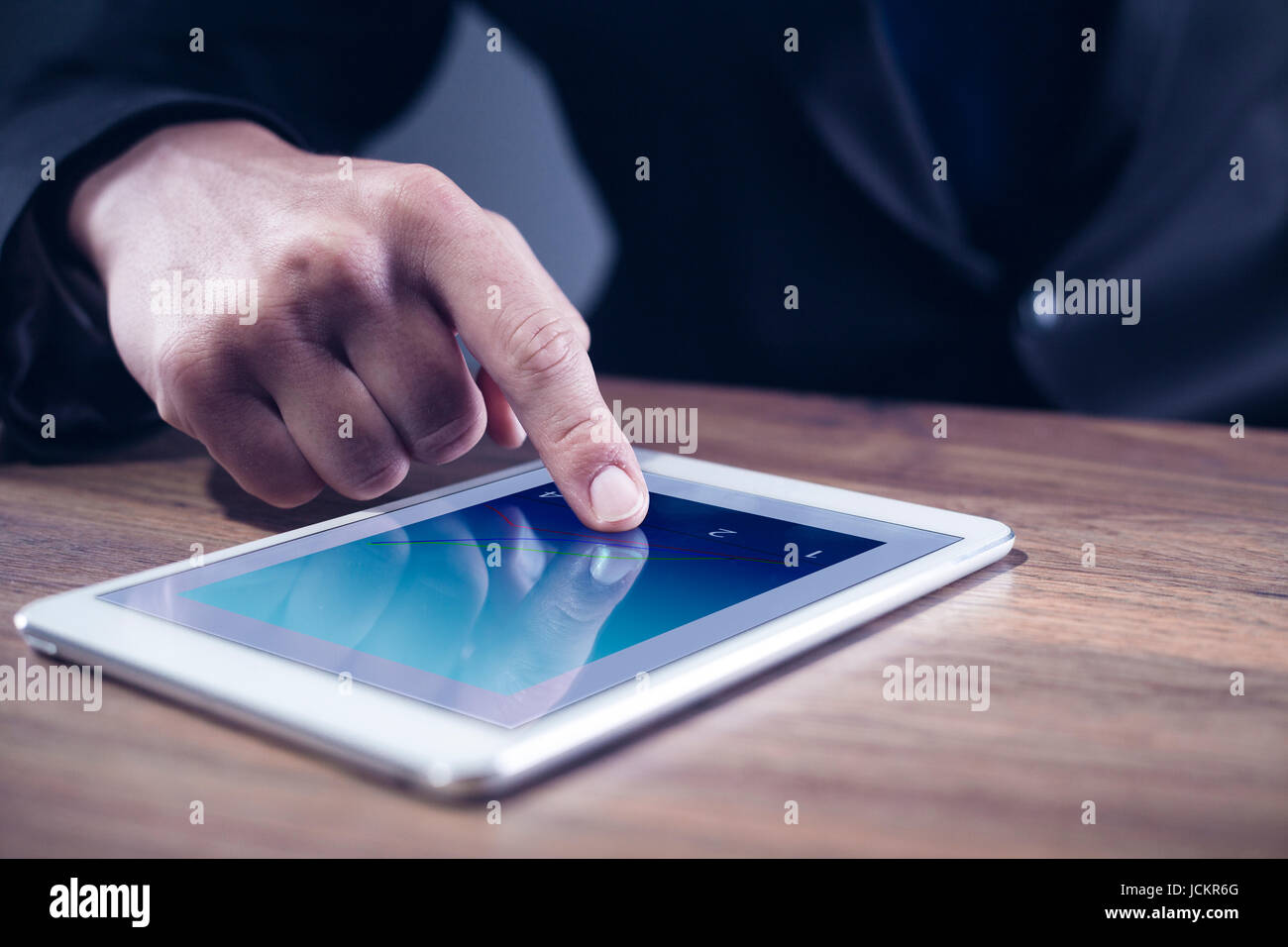 Mans hand touching on a tablet computer Stock Photo