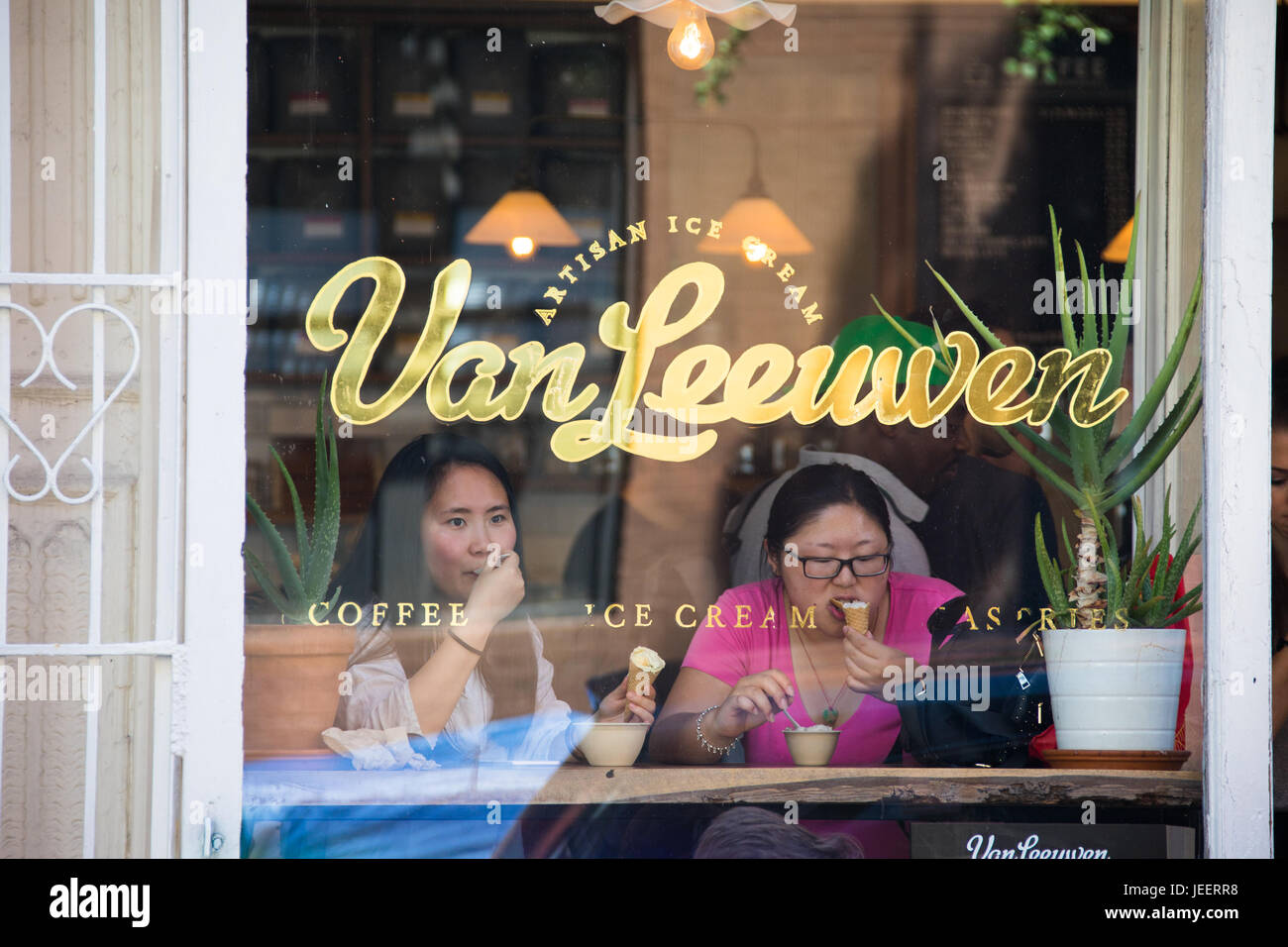 Asian tourists eating ice cream at Van Leeuwen Artisan Ice Cream, East Village, Manhattan, New York Stock Photo