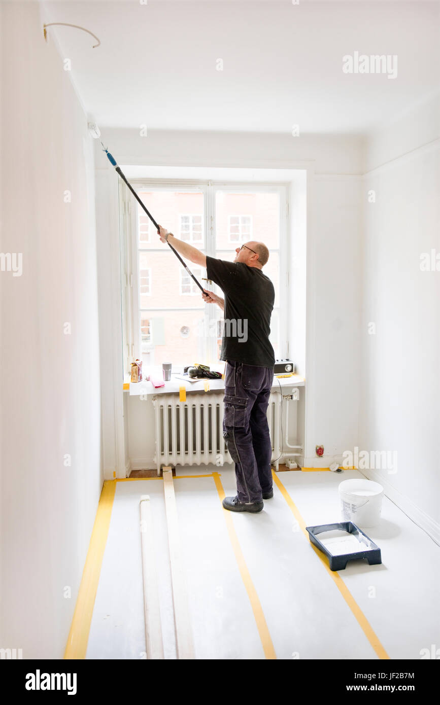 Man painting room Stock Photo - Alamy