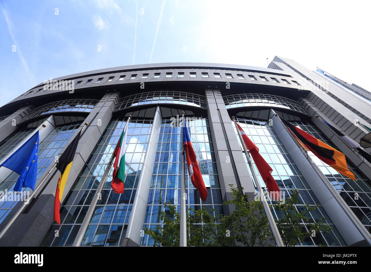 Brussels, Belgium - July 17, 2017: Flags on European Parliament building background. Flags of EU countries opposite facade of European Parliament buil Stock Photo