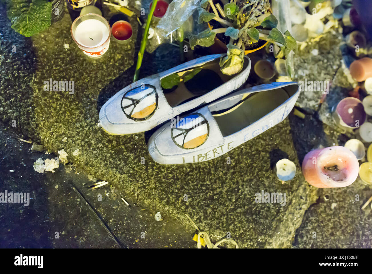 shoes with peace and love, french flag, and the eiffel tower. Homage at the victims of the terrorist attacks in Paris the 13th of november 2015. Stock Photo