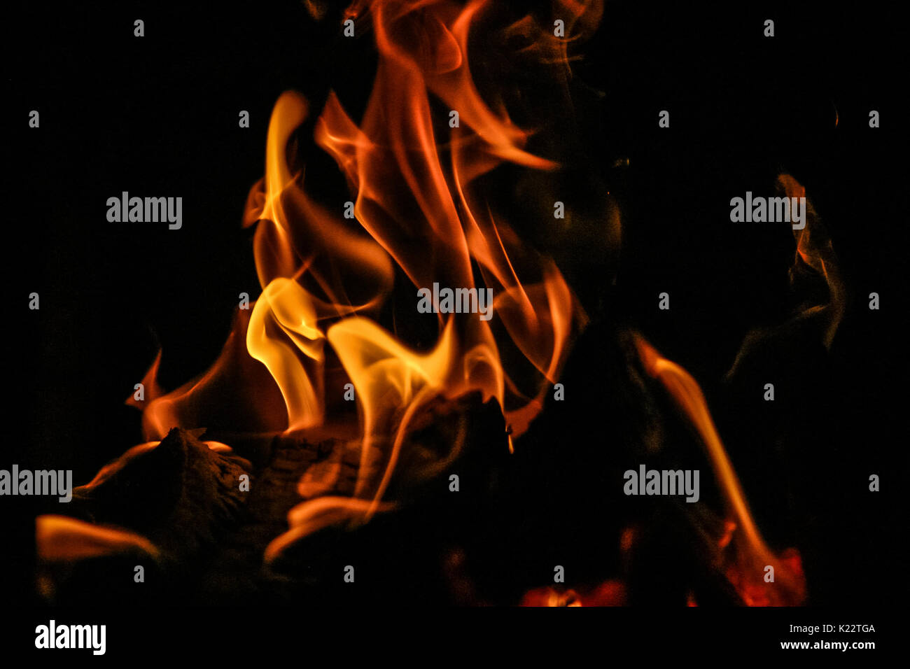 Fire burning inside a brick stove - wood, ash, flames. Stock Photo