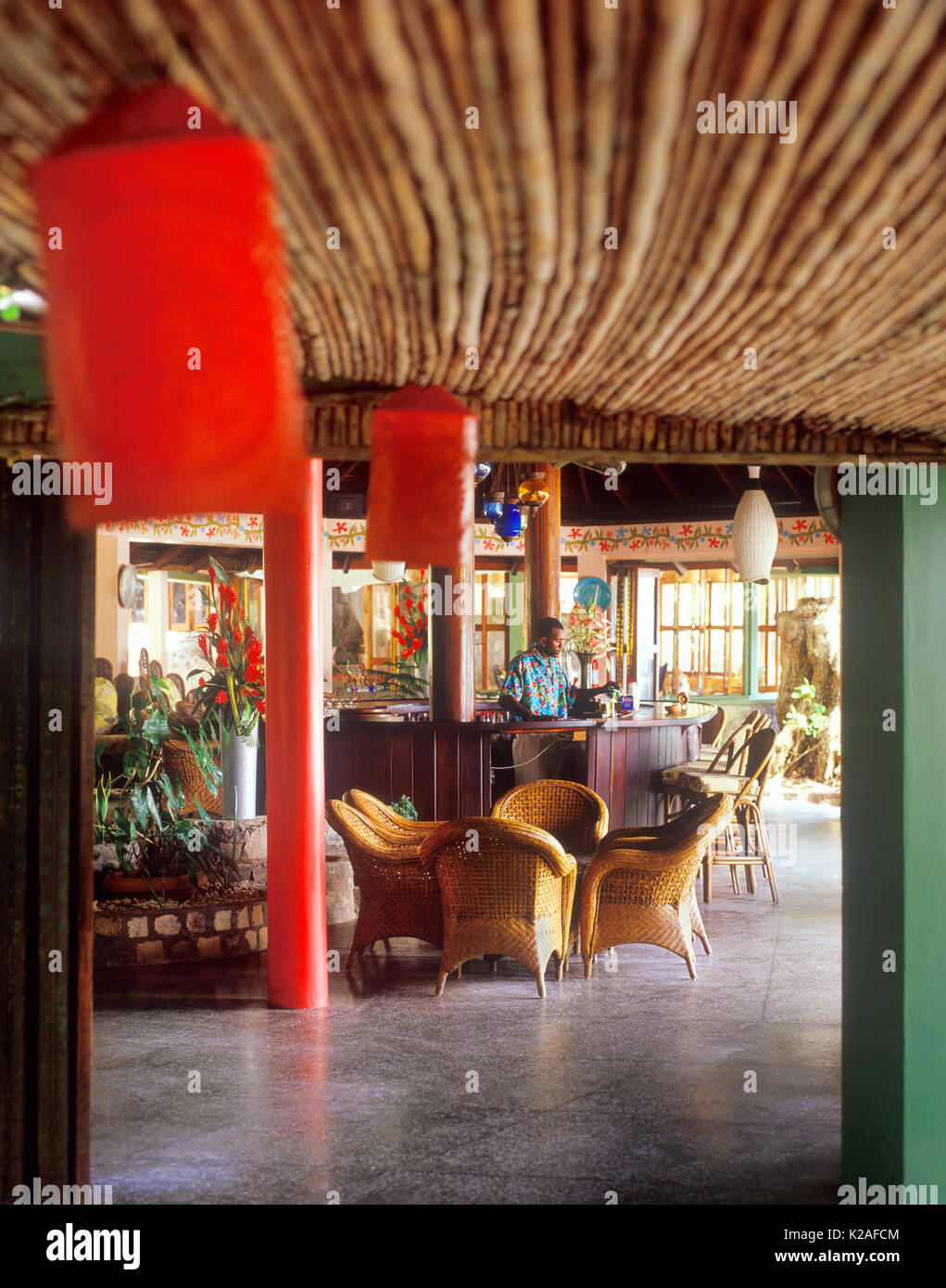 A bartender pours a beer at the Captain Bligh bar at Young Island resort. Kingstown, St. Vincent Stock Photo