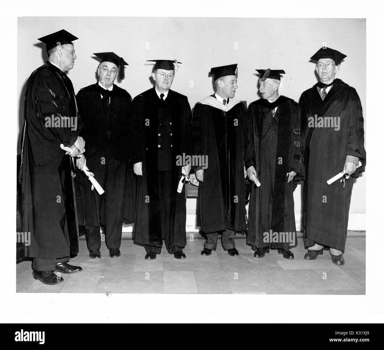 Commemoration Day 1951 at Johns Hopkins University, showing biophysicist Detlev Wulf Bronk standing with honorary degree recipients, US Army Colonel Justin Meredith Andrews, immunologist Warfield Theobald Longcope, biochemist Elmer Verner McCollum, pediatrician Edwards Albert Park, professor of anatomy Lewis Hill Weed, and humanities scholar Henry Allen Moe, all in graduation garb, Baltimore, Maryland, February 22, 1951. Stock Photo