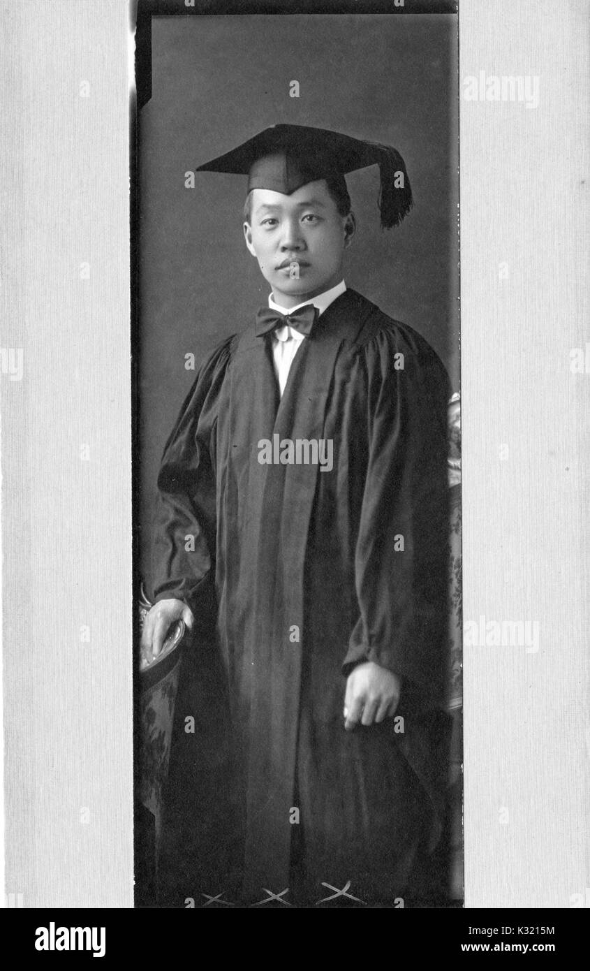 A knees up portrait of a male student in graduation cap at 22 years of age, 1917. Stock Photo