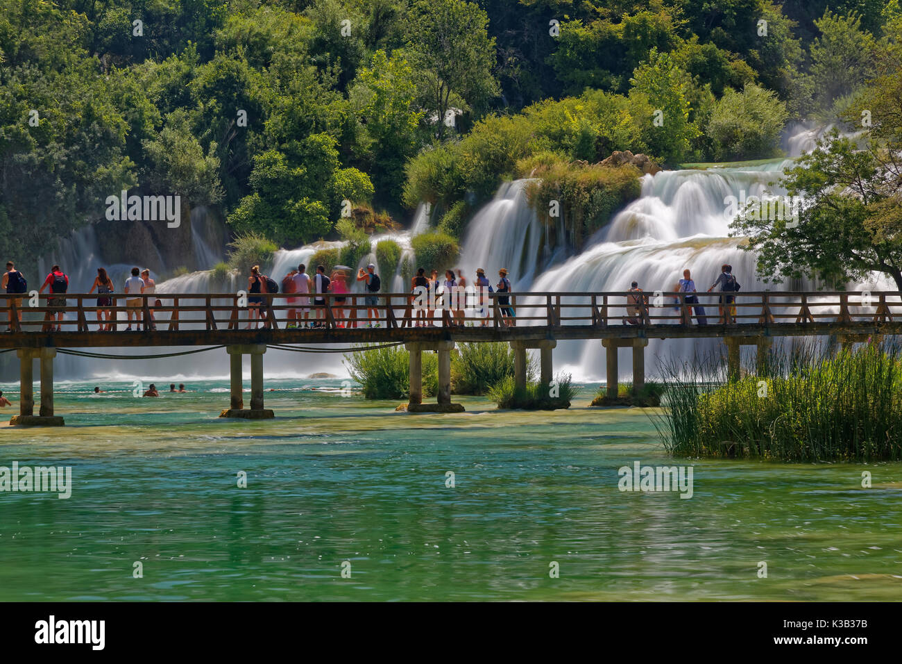 Tourists bathe at the waterfall Smotorcycleinski Buk, National Park Krka, Sibenik-Knin, Dalmatia, Croatia Stock Photo