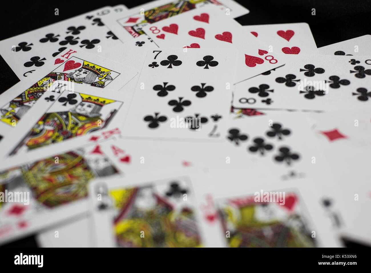 Playing cards splattered over a table Stock Photo