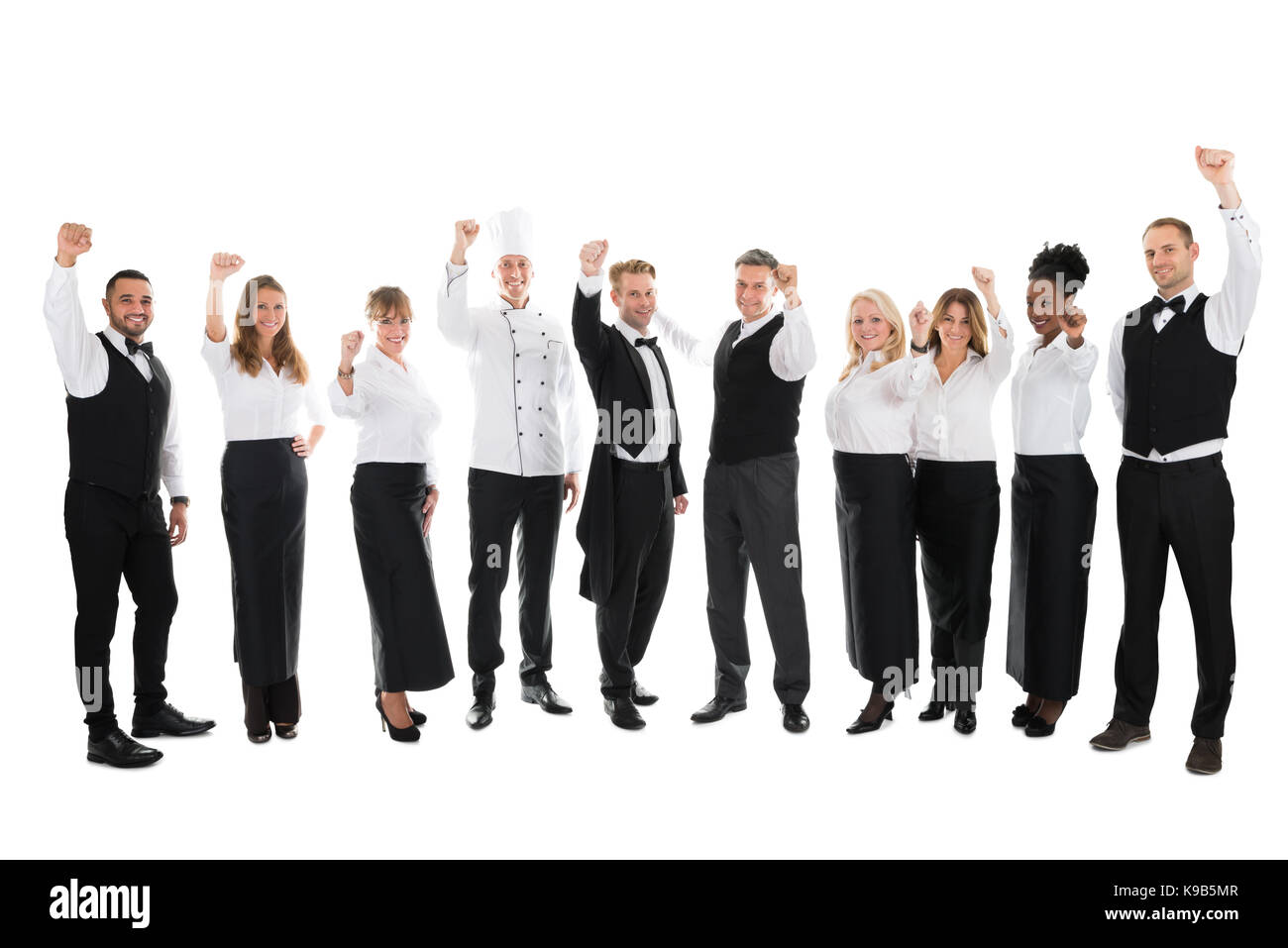 Full length portrait of happy restaurant staff celebrating success against white background Stock Photo