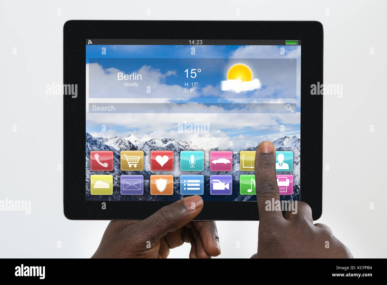 Close-up Of A Person's Finger On Digital Tablet With Multicolored Apps On It Stock Photo