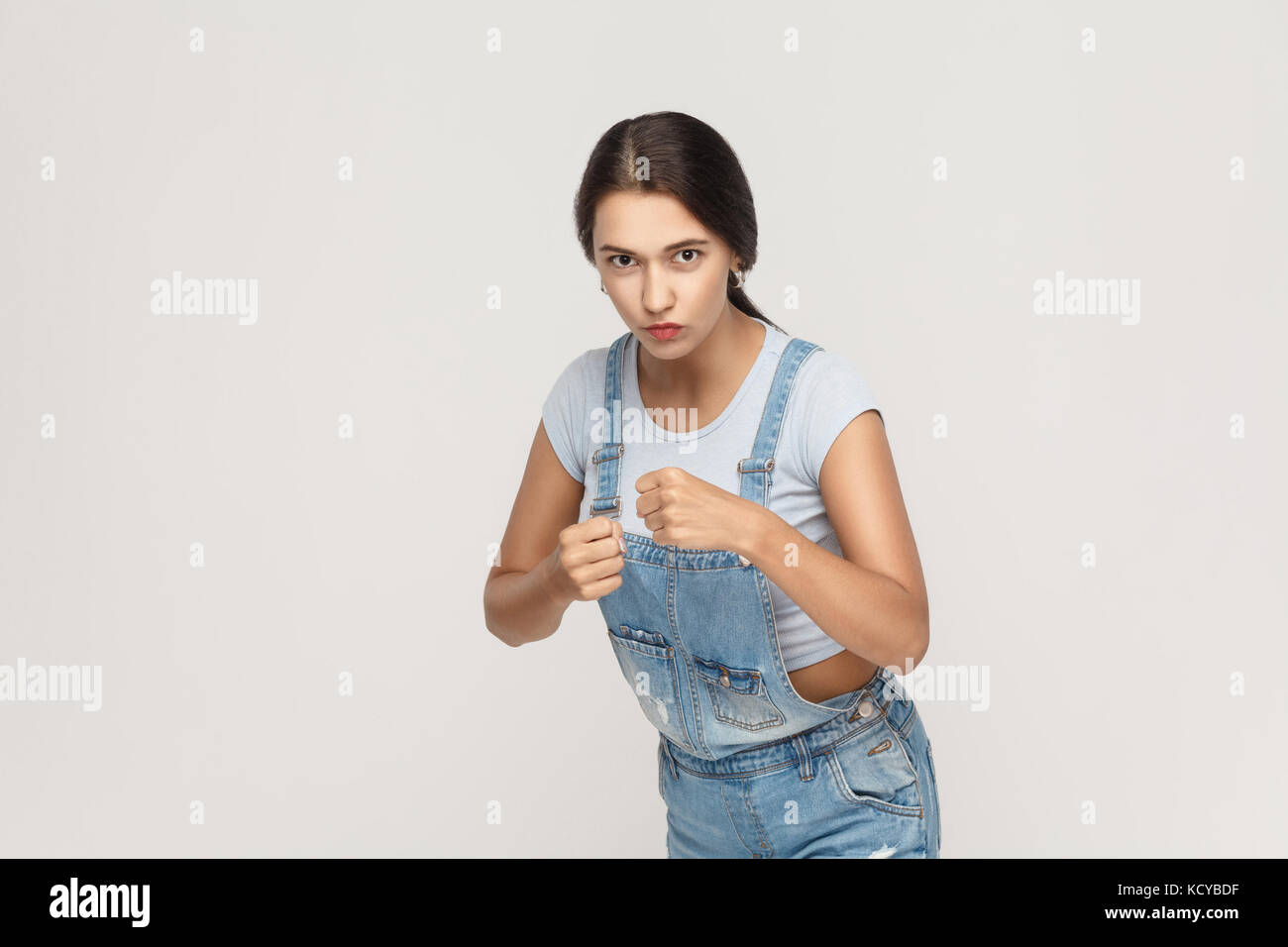 Boxing. Young adult indian woman, ready for fight on gray background. Stock Photo