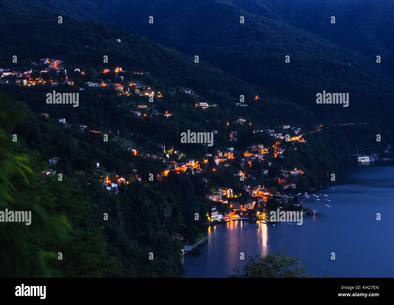 night on lake como, italy. illuminated houses and a marina for sightseeing Stock Photo