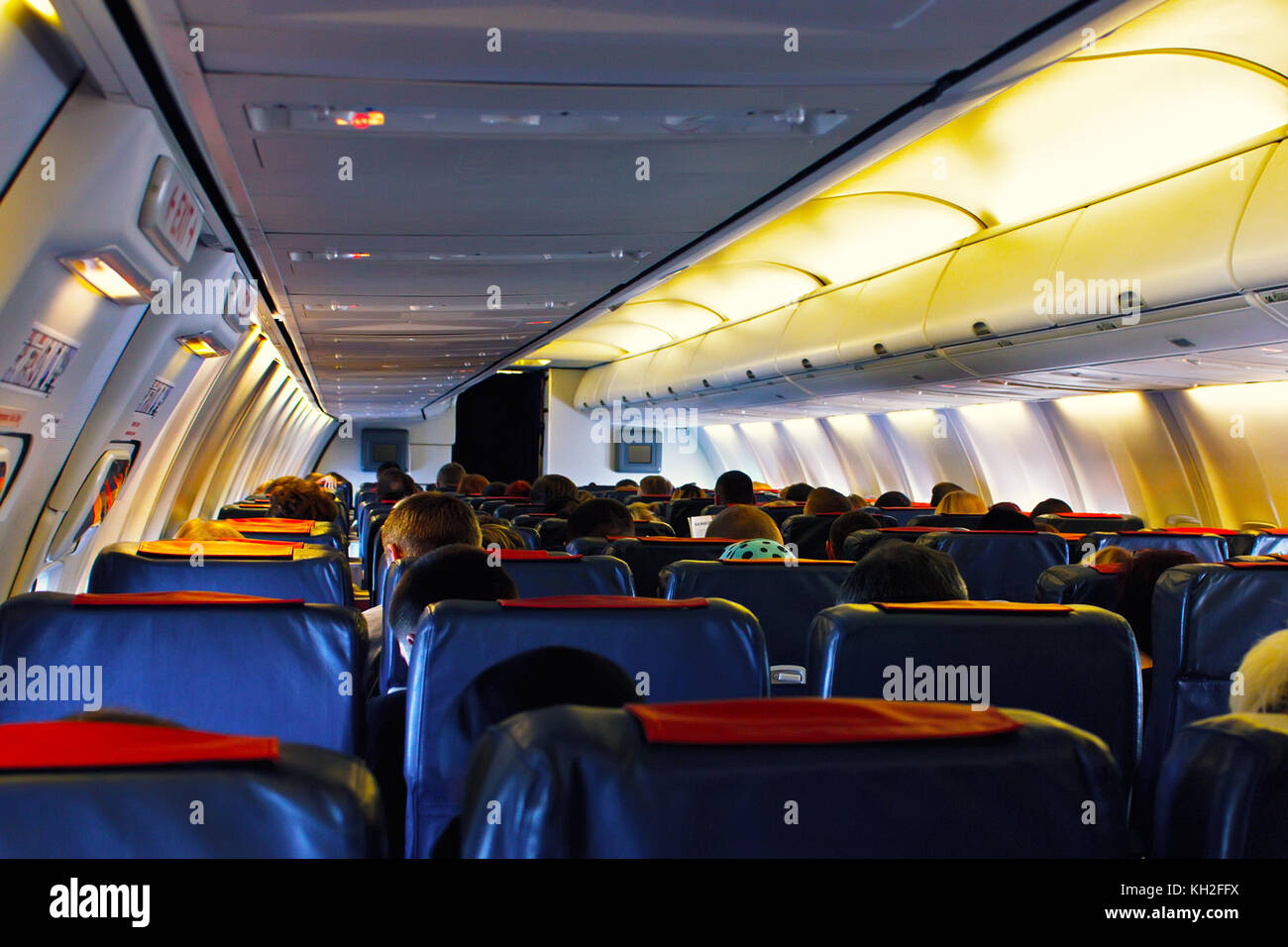 Passenger seat, Interior of airplane with passengers sitting on seats ...