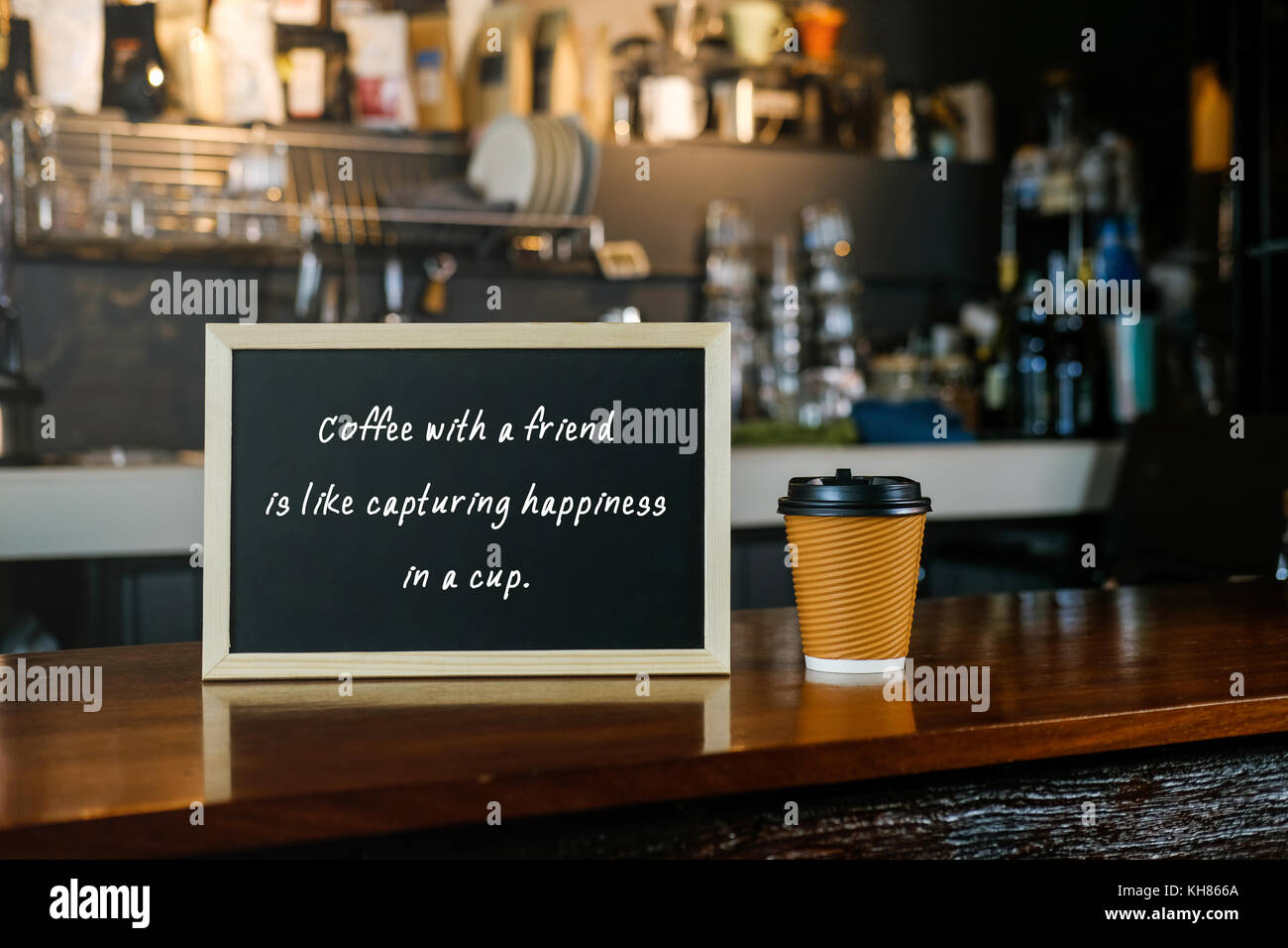 Black board with quote Coffee with a friend is like capturing happiness ...