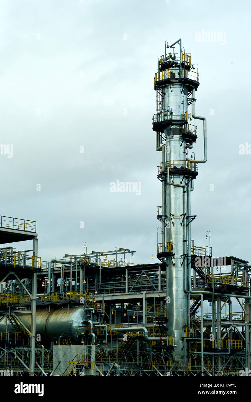 Section of the distillery plant of a modern oil refinery with a fractionating column, tanks and pipelines Stock Photo