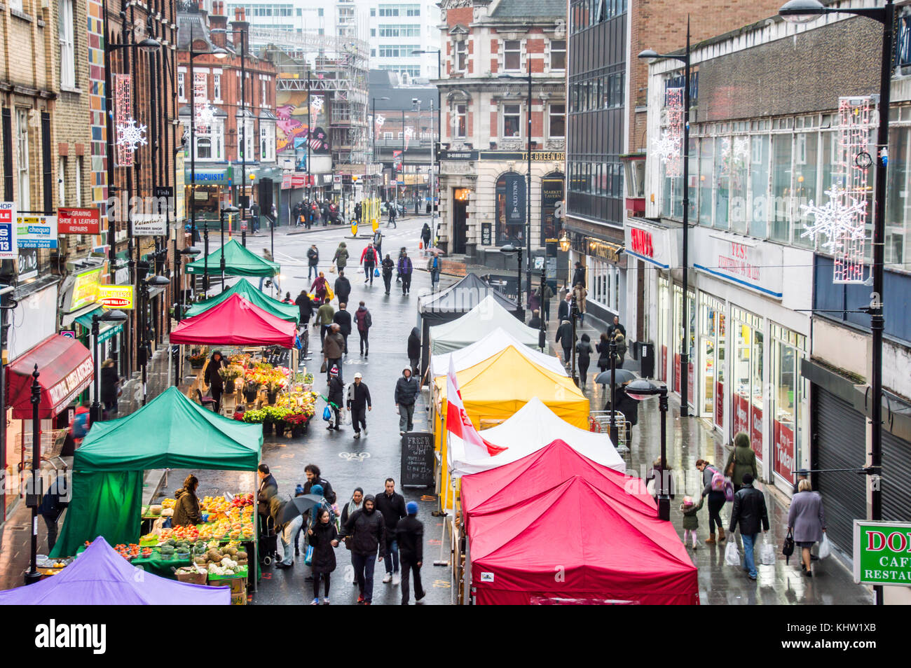 Croydon Surrey street market on a rainy day with sellers selling fruits and vegetables Stock Photo