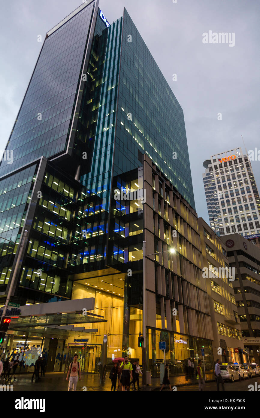 Modern glass skyscraper at evening time in the city (Deloitte Centre, Auckland, New Zealand) Stock Photo