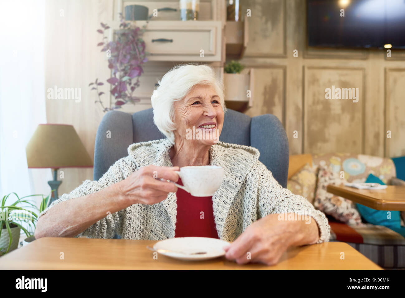 Happy Senior Lady Enjoying Tea Stock Photo