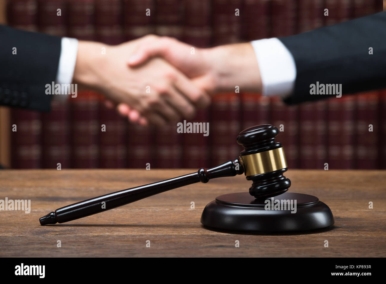 Judge And Client Shaking Hands At Courtroom Stock Photo