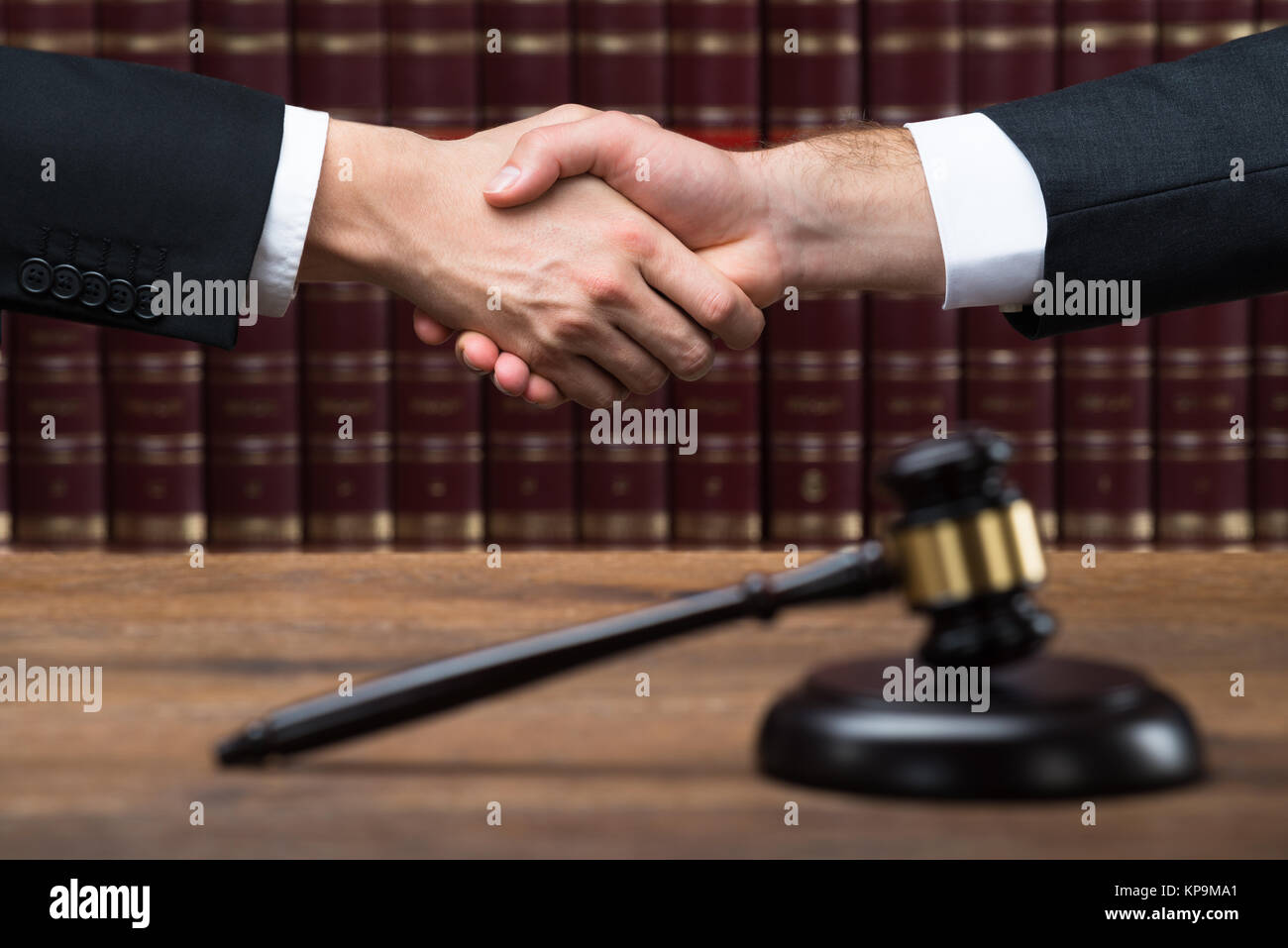 Judge And Client Shaking Hands At Courtroom Stock Photo