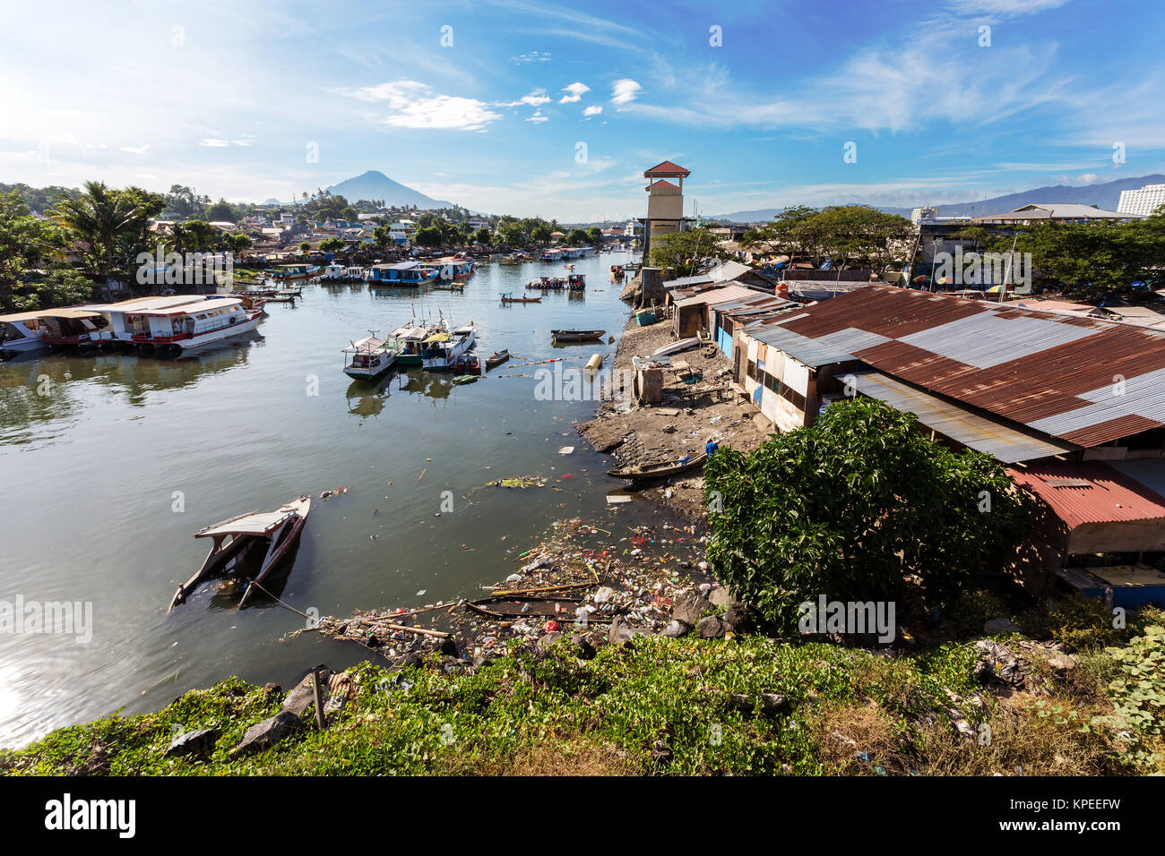 poor houses by the river in shantytown Stock Photo