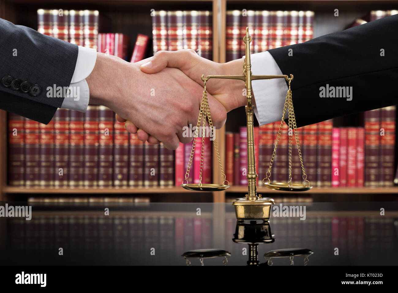 Justice Scale With Judge And Client Shaking Hands Stock Photo