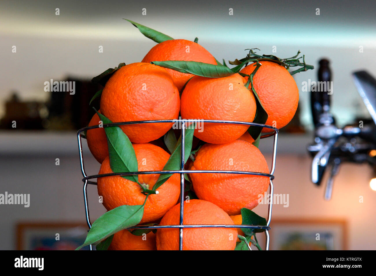 Close-up of a metal basket with orange fruits at a bar in spain. Stock Photo