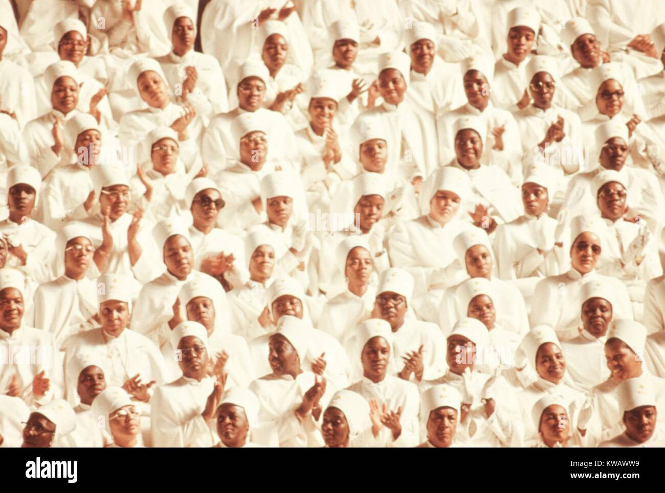 Black Muslim women dressed in white garb applaud Elijah Muhammad during his annual Savior's Day Message in Chicago, Illinois, 1974. Image courtesy John White/US National Archives. Image courtesy National Archives. Stock Photo